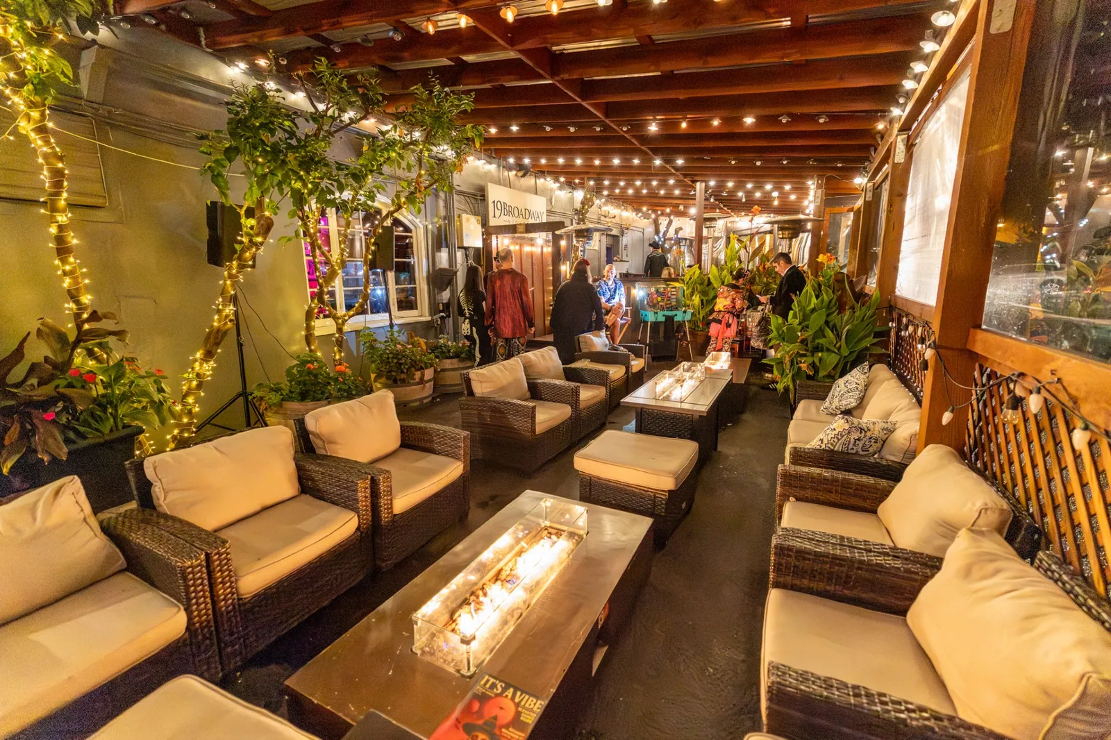 Mac’s outdoor deck with warm string lights, fire tables and lounge seating